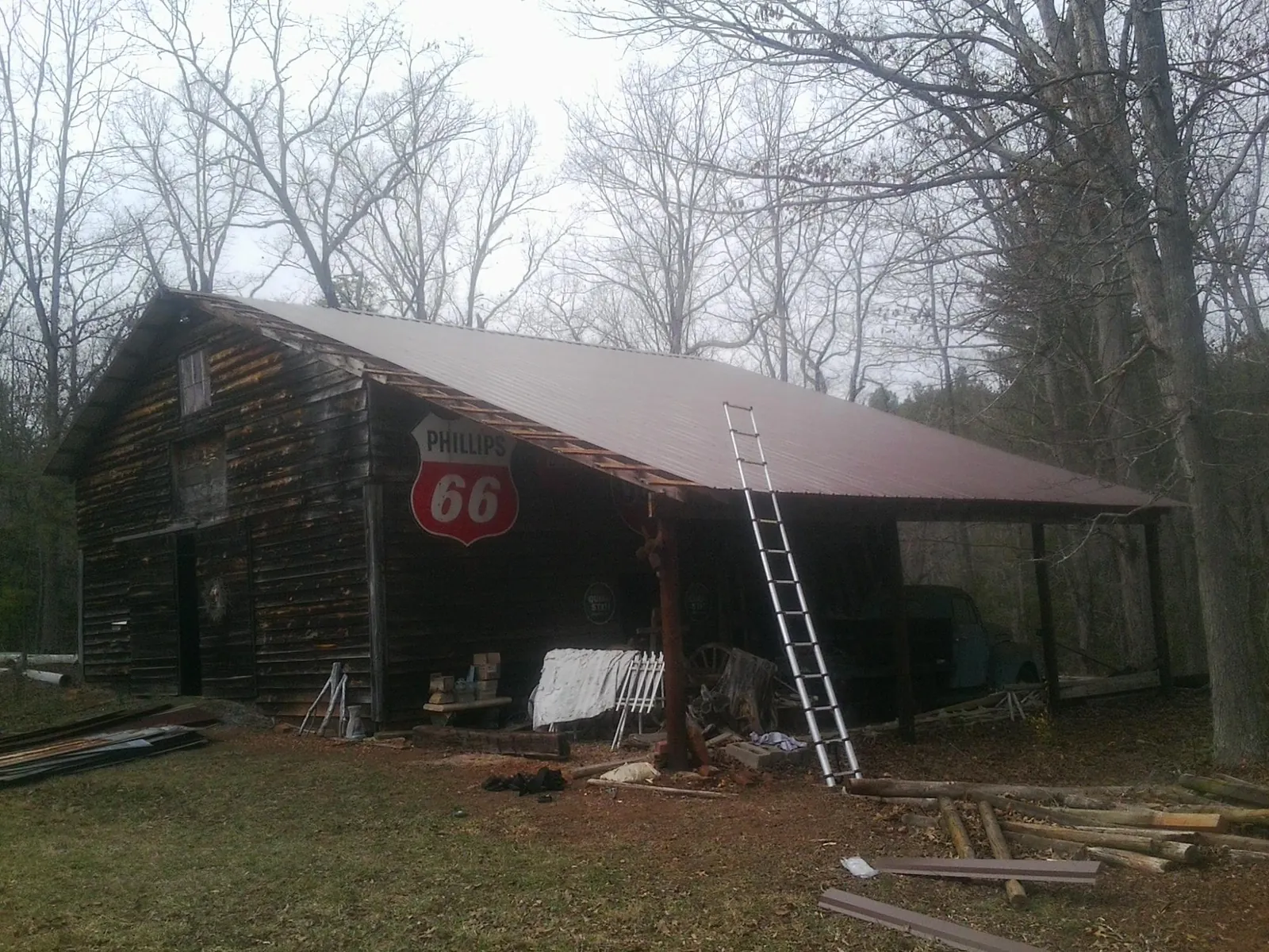 New metal roof on an open sided timber barn with a vintage sign in Bancroft